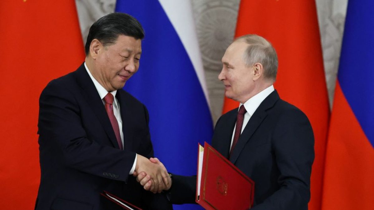 Chinese President Xi Jinping and Russian President Vladimir Putin shake hands after signing joint documents following their talks at the Kremlin in Moscow.