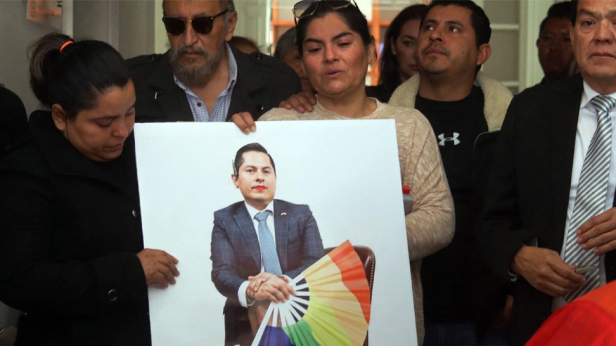 Relatives of Jesus Ociel Baena, Mexico's first openly non-binary magistrate, attend a posthumous tribute at the Electoral Court of the State of Aguascalientes, in Aguascalientes, Mexico, on November 14, 2023. Baena, whose death sparked protests and anger among the LGBTQ community, appears to have been the victim of a murder-suicide committed by their partner, investigators said Tuesday. Despite prosecutors ruling out the presence of a third person at the scene, protesters gathered in Mexico City insisting Baena -- the first Mexican citizen to be granted a non-binary passport -- was the victim of a hate crime. (Photo by AFP)