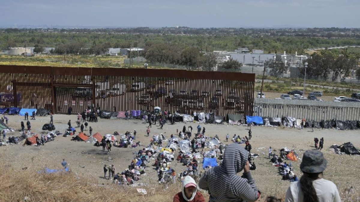 Migrants stuck between the primary and secondary fencing at the Tijuana-San Diego border