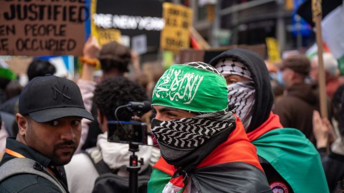 Manifestantes pro Hamás, uno con la bandera del grupo terrorista, protestan en Nueva York un día después de la masacre de Hamás.