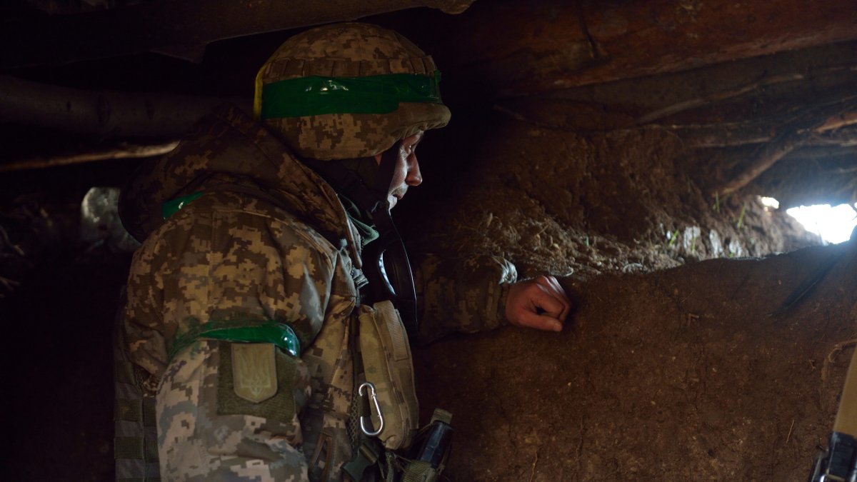 A Ukrainian fighter in a trench on the Bakhmut front.