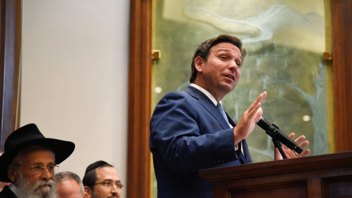 Florida Governor Ron DesSantis giving a speech behind a lectern.