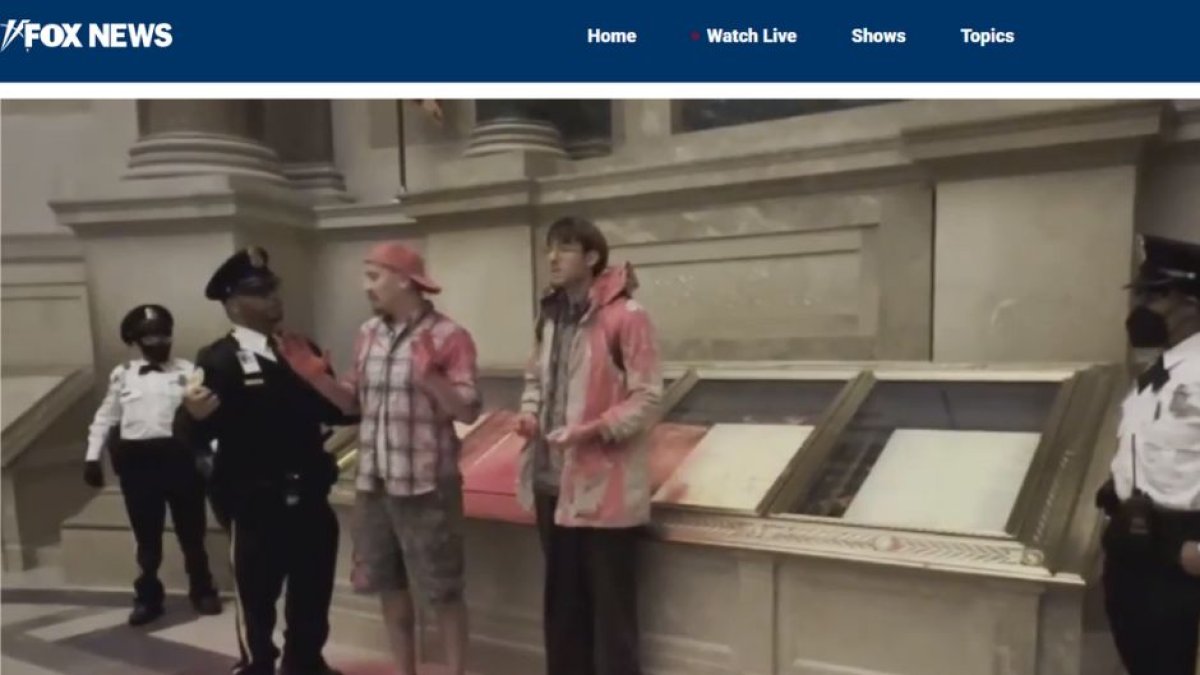 National Archives Rotunda evacuated after climate activists dump pink powder on case holding US Constitution