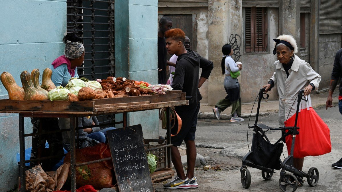 People buy food on a street in Havana