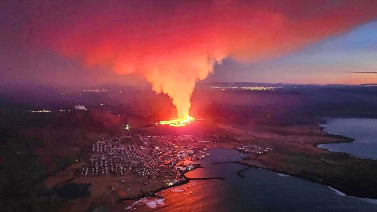 TOPSHOT - Billowing smoke and flowing lava are seen in this Icelandic Department of Civil Protection and Emergency Management , January 14, 2024, handout image during an volcanic eruption on the outskirts of the evacuated town of Grindavik, western Iceland.