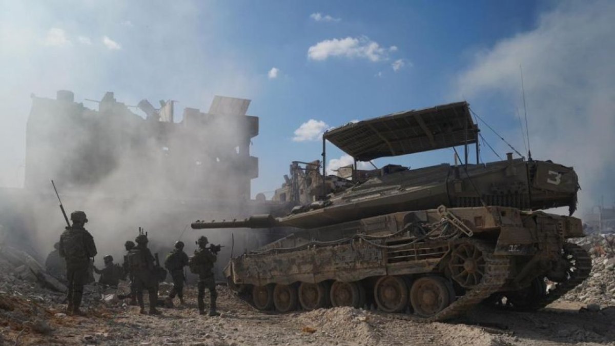 Israeli soldiers next to an armored vehicle in Gaza,