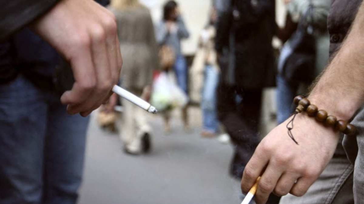 Dos hombres fumando un cigarrillo en una calle parisina