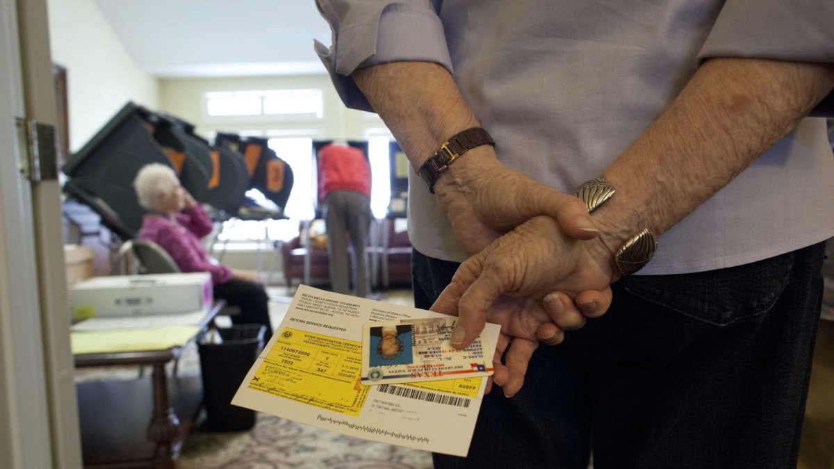 Seniors line up for early voting Friday at The Summit assisted living center in Austin, Texas in advance of Tuesday's general election that will decide the President of the United States and many other races. Participation was high as dozens lined the hallways to cast their electronic  ballots - October 26, 2012. ©Bob Daemmrich / The Image Works