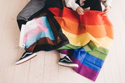 Two children play with the trans and LGBT flags.