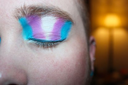 Ojo cerrado con una sombra de maquillaje representando la bandera Trans.