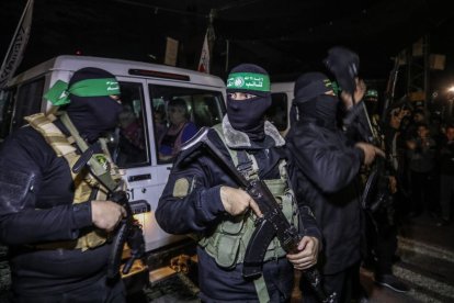 Hamas fighters handing over hostages to the Red Cross.