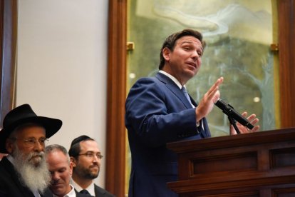 Florida Governor Ron DesSantis giving a speech behind a lectern.