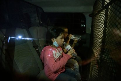 Two minors drink water after crossing the border in Rio Grande in a file photo.