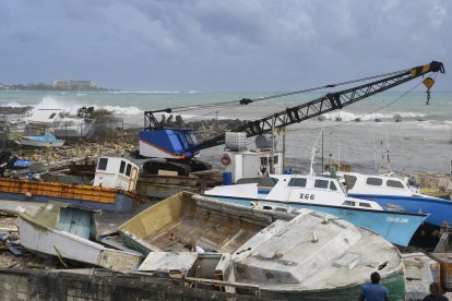 Damaged fishing boats rest on the shore after the passing of Hurricane Beryl at the Bridgetown Fish Market, Bridgetown, Barbados on July 1, 2024. (Photo by Randy Brooks / AFP)