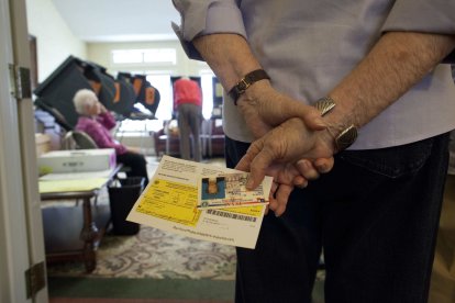 Seniors line up for early voting Friday at The Summit assisted living center in Austin, Texas in advance of Tuesday's general election that will decide the President of the United States and many other races. Participation was high as dozens lined the hallways to cast their electronic  ballots - October 26, 2012. ©Bob Daemmrich / The Image Works