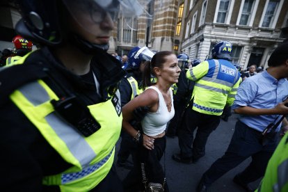 Police detain a protester during the