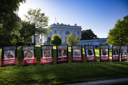 The signs with the faces of arrested immigrants on the driveway to the White House.