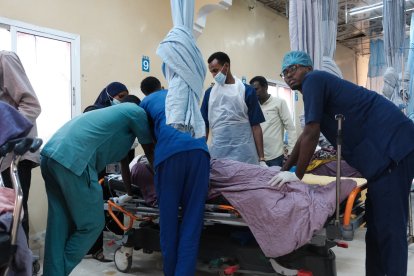 A group of health workers tend to a patient at a hospital in Sudan