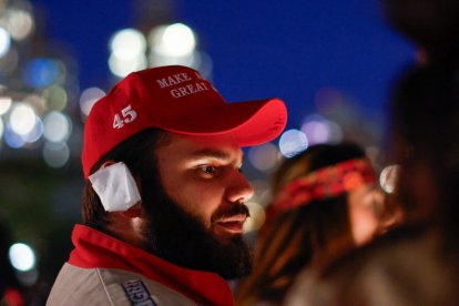 A man wears a MAGA hat and a bandaged ear during New York Young Republican Club's 6th annual MAGAWEEN party.