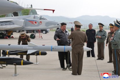 Kim Jong Un next to aerial weaponry