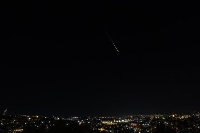 This picture shows a rocket trail from Israel's Iron Dome missile-defense system batteries fired to intercept rockets fired from Iran.