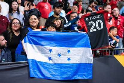 Aficionados hondureños sostienen la bandera de Honduras