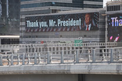 A banner with an image of U.S. President Donald Trump, accompanied by a message, is displayed in Tel Aviv on June 22