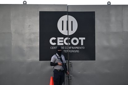 A security officer stands guard at an entrance of the Terrorism Confinement Center (CECOT).
