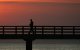 Un hombre solitario camina por un muelle
