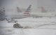A snow plow works to clear the runways at Logan Airpot in Boston, Massachusetts, on January 25, 2026. A massive winter storm on January 24 dumped snow and freezing rain from New Mexico to North Carolina as it swept across the United States towards the northeast, threatening tens of millions of Americans with blackouts, transportation chaos and bone-chilling cold. After battering the country's southwest and central areas, the storm system began to hit the heavily populated mid-Atlantic and northeastern states as a frigid air mass settled in across the nation. (Photo by Joseph Prezioso / AFP)