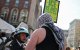 Protester argues with police at anti-Israel protest.