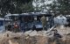 Israeli security and emergency service members deploy at the impact site of an Iranian missile at a bus depot in Herzliya near Tel Aviv on June 17, 2025.