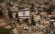 An Israeli flag flutters in the wind over the Arab East Jerusalem neighbourhood of Silwan