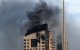 Smoke rises from a high-rise building following a drone attack in Kuwait City