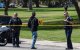 Un hombre lleva flores mientras agentes de la policía de San Diego bloquean el acceso