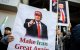 Demonstrators hold placards of US President Donald Trump with text that reads "Make Iran Great Again" during a rally supporting political change near the Iranian embassy in Tokyo on March 17, 2026. (Photo by Philip FONG / AFP)