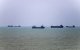 In this picture obtained from Iran's ISNA news agency on June 18, 2026, vessels are seen anchored in Bandar Abbas along the Strait of Hormuz. Oil prices tumbled after Trump and his Iranian counterpart separately signed their accord to end the Middle East war, with the Strait of Hormuz to reopen but two months of negotiations lying ahead. (Photo by AMIRHOSSEIN KHORGOOEI / ISNA / AFP) /