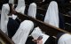 A nun looks through the program of the Solemn Vespers evening prayer at St. Patrick's Cathedral in New York