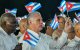 Miguel Díaz-Canel (derecha), y el presidente del Parlamento, Esteban Lazo, ondean banderas de papel durante la celebración del 73.º aniversario del asalto guerrillero al Cuartel Moncada