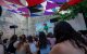 Wide view of a drag performer in a green costume on stage (Files)