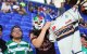A fan of Santos Laguna wears a mask while holding up a jersey during a soccer match against Santos Laguna at Sports Illustrated Stadium in Harrison, New Jersey, on August 6, 2026. (Photo by Gordon Donovan/NurPhoto) (Photo by Gordon Donovan / NurPhoto via AFP)