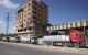 Trucks carrying aid provided by the World Food Programme (WFP) drive on a road in Deir el-Balah