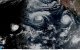 This handout satellite image obtained from the National Oceanic and Atmospheric Administration (NOAA)/GOES shows Hurricane Lowell (L).