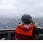 Un miembro de la Guardia Costera de Taiwán vigila los movimientos de un buque de guerra chino.