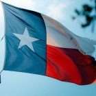 Una bandera texana, deshilachada, ondea al viento.