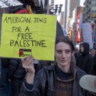 October 13, 2023, New York, United States: A woman holds a placard reading ''American Jews For A Free Palestine'' during a Palestinian Day of Action protest in Times Square, New York City. Across the country and around the world, people are holding rallies and vigils for both Palestinians and Israelis following a surprise attack by Hamas on October 7. The attack has resulted in a bombardment of Gaza by the Israeli military and a a possible ground invasion of the territory. (Credit Image: © Ron Adar/SOPA Images via ZUMA Press Wire)