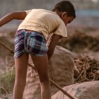 Imagen de un niño trabajando en el campo.