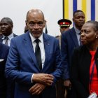 Haitian Prime Minister Ariel Henry (3rd-L) leaves the auditorium after speaking to students during a public lecture on bilateral engangement between Kenya and Haiti