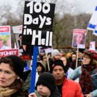 Demonstrators carry Israeli flags and placards with the portraits of Israeli hostages during a march to mark the 100th day of the Israeli hostages' captivity during the ongoing Israeli-Palestinian conflict, on January 14, 2024 in Berlin.