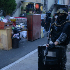 Un policía durante una redada en un barrio de Guayaquil, este 8 de mayo. (Foto por Gerardo MENOSCAL / AFP)